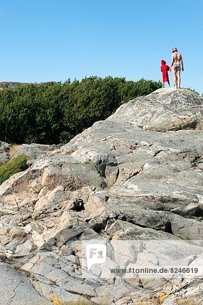 Woman with son on cliff