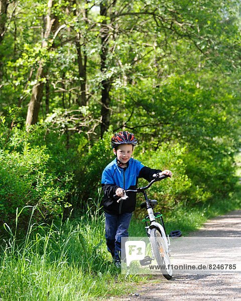 Smiling boy with bike