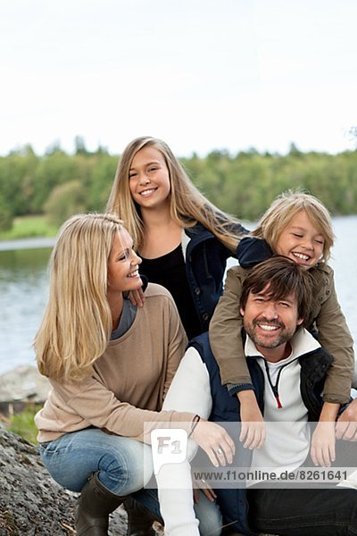 Portrait of family by lake