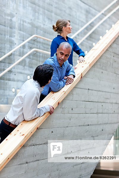 Men and woman talking on stairs