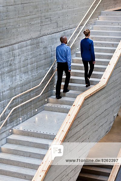 Man and woman walking on stairs