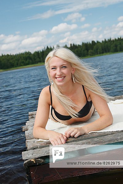 Young woman on log raft
