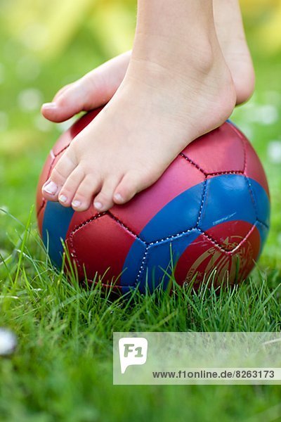 Childs feet on ball  close-up