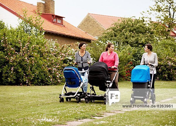 Women walking with baby carriages  Sweden.