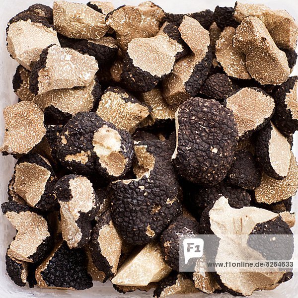 Black truffles on white background