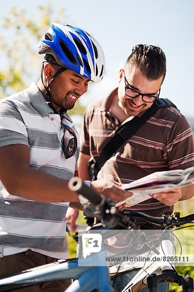 Two cyclists with map
