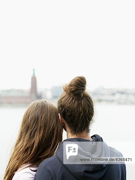 Rear view of young couple looking at view