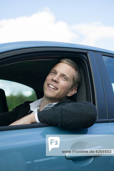 Smiling young man in car