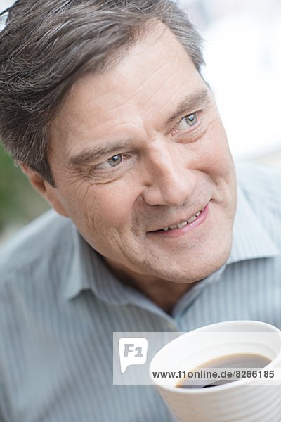 Smiling mature man drinking coffee