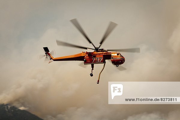 The forest fire of High Park Fire on the slopes of Lory State Park. Forest Fire Firefighting helicopter.