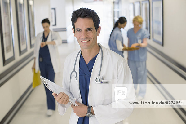Portrait of smiling doctor in hospital corridor