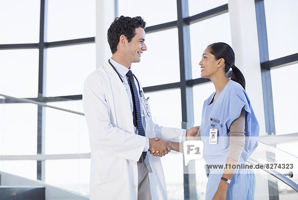 Doctor and nurse handshaking