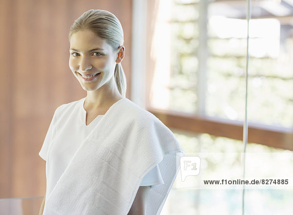 Portrait of smiling masseuse in spa