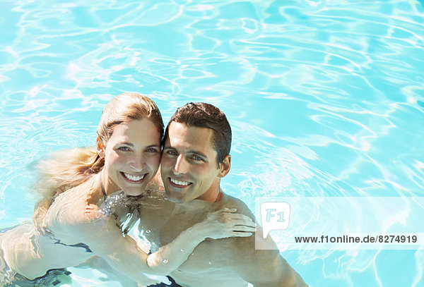 Portrait of smiling couple in swimming pool
