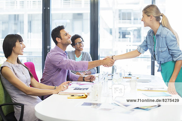Business people shaking hands in meeting