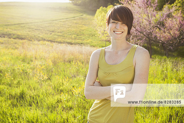 Young Woman In Grassy Field In Spring.