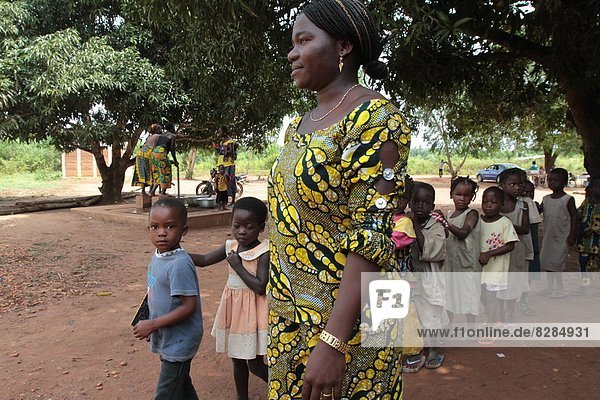 Teacher accompanying students to school  Hevie  Benin  West Africa  Africa