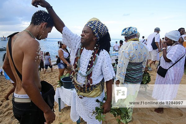 Candomble priest performing a ritual during Lemanja festival in Rio Vermelho  Salvador  Bahia  Brazil  South America