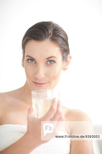 Portrait of woman holding glass of mineral water