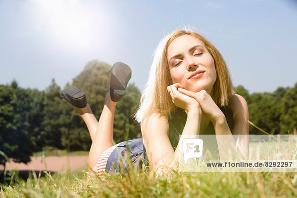 Young woman enjoying sunshine in park