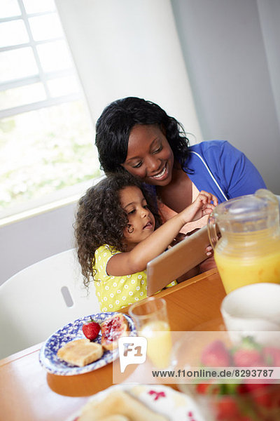 Mother and daughter having breakfast