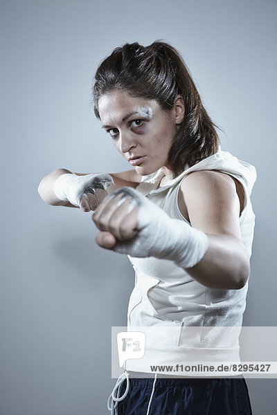 Portrait of a young female boxer in defending position