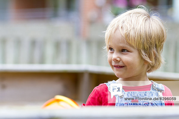 little girl playing in a sandbox
