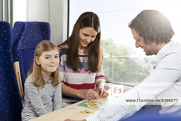 Happy family playing in a train