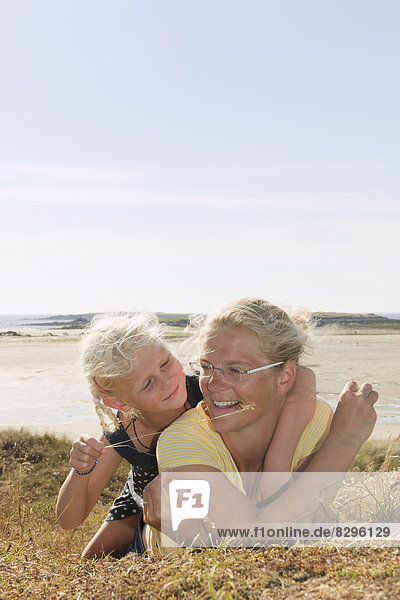 France  Bretagne  Landeda  Mother and daughter lying at the coast