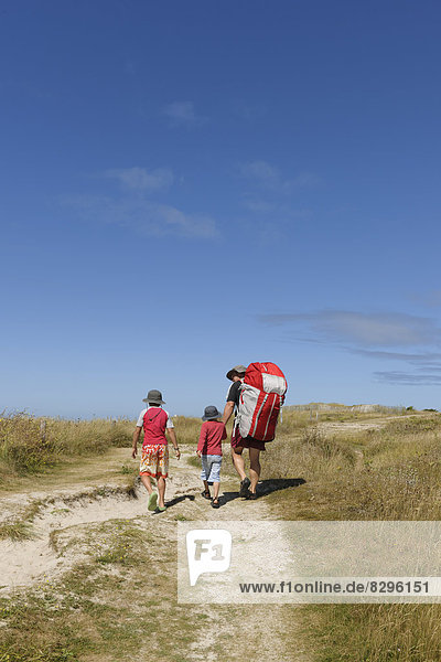 France  Bretagne  Landeda  Father with two sons walking in dune