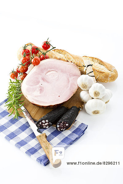 Ham  sausages  tomatoes  garlic  rosemary and bread  studio shot