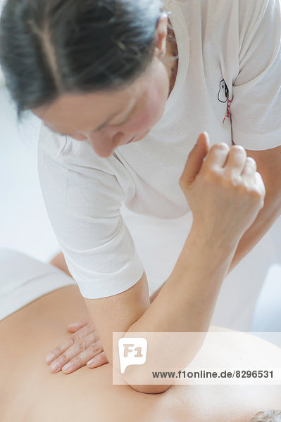 Traditional Chinese Medicine  TCM  female therapist during Tuina massage