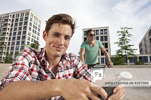 Young man with e-book outdoors