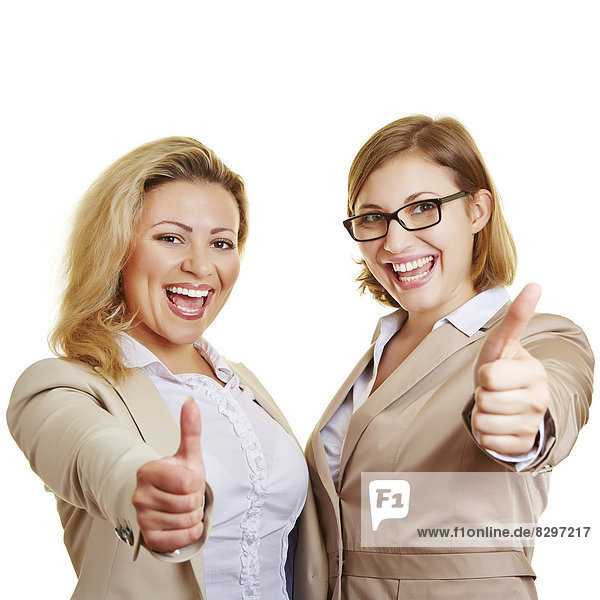 Two businesswomen giving thumbs up  studio shot
