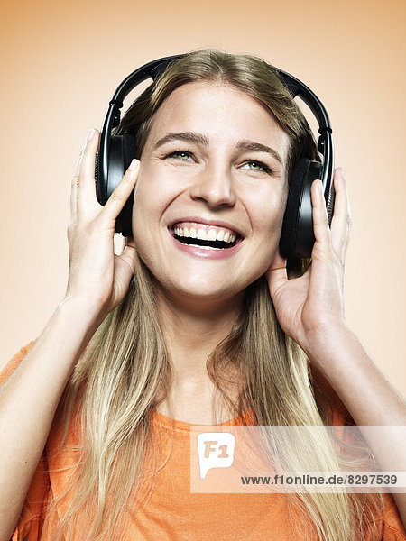 Portrait of young woman with headphones  studio shot