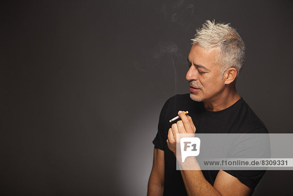 senior man smoking a cigarette cool stylish studio