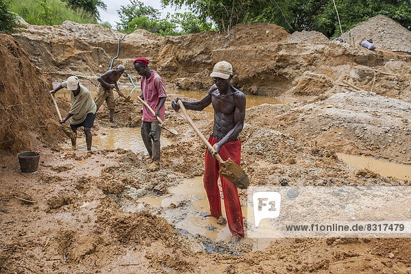 Workers digging at a diamond mine in the jungle