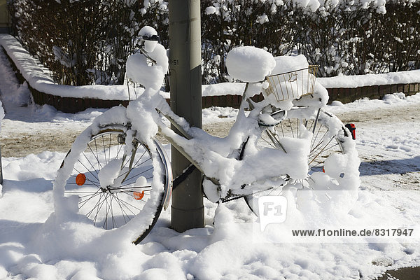Snow-covered bicycle