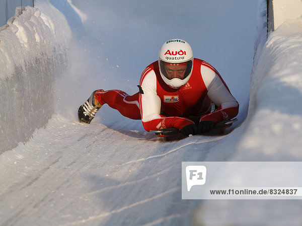 Man riding a skeleton sled at the Innsbruck bobsleigh track  Igls Olympic Bobsled Run