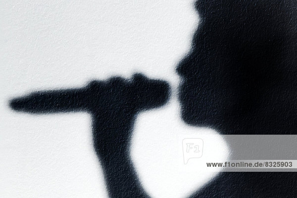 Schatten einer Sängerin mit Mikrofon