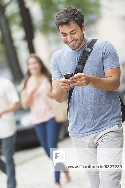Man texting in street