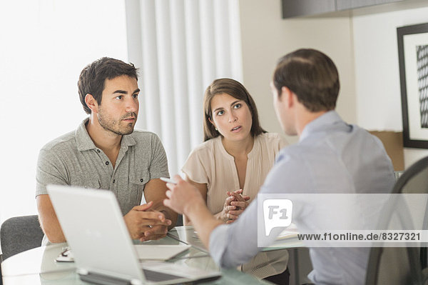 Customers talking to advisor in office