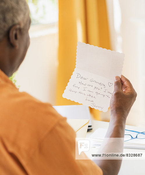 Rear view of man reading message