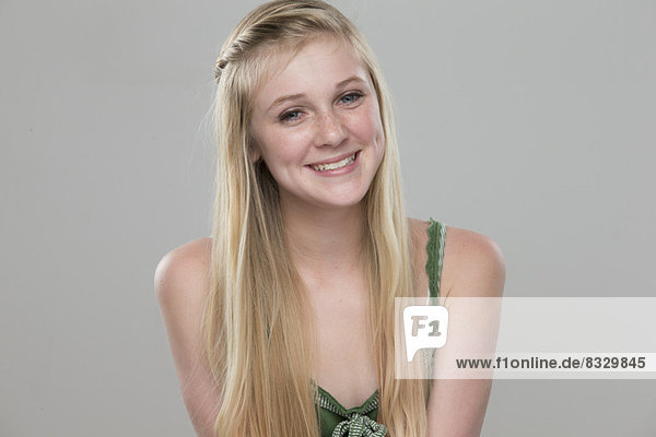 Portrait of teenage girl (14-15) smiling