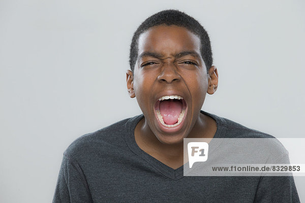 Portrait of teenage boy (14-15) shouting
