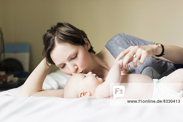 Mother kissing baby boy (2-5 months)