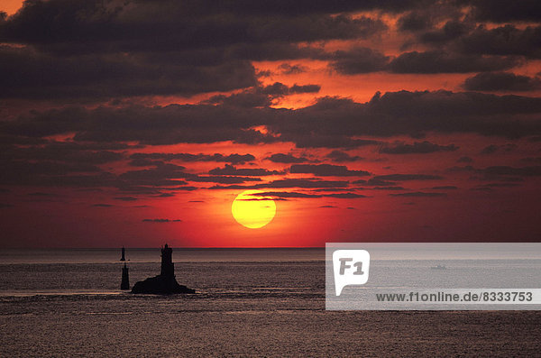 'Lighthouse of ''La Vieille'' situated in the ''Pointe du Raz'' headland Here  into the light at sunset'