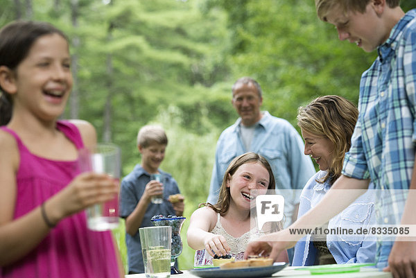 Organic Farm. An outdoor family party and picnic. Adults and children.