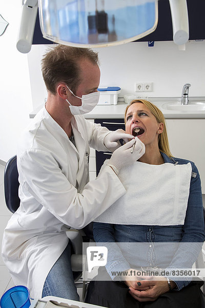 Woman at the dentist  dentist checking her teeth  Germany