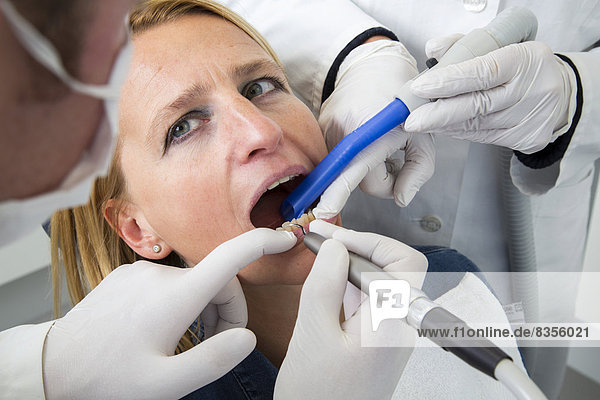 Woman receiving treatment at the dentist  Germany